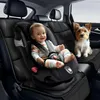 A baby in a car seat and a dog sitting on a car seat in the back of a car. Anteprima dell’immagine prodotto