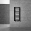 A black radiator is mounted on a tiled wall in a modern bathroom setting. Náhled obrázku produktu