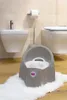A baby potty is placed on a white rug in a bathroom with a bidet and toilet in the background. Produktbild-Vorschau