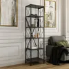 A tall, anthracite-colored bookshelf filled with books and decorative items, placed in a living room setting next to a sofa. Podgląd zdjęcia produktu