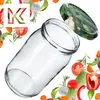 A clear glass jar with a lid featuring a pattern of pickles, surrounded by various fresh vegetables and herbs. Podgląd zdjęcia produktu