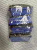 A stack of blue and black vacuum cleaner filters inside a clear plastic bag. Produktbild-Vorschau