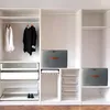 An organized closet with shelves, drawers, hanging clothes, and storage boxes. Náhled obrázku produktu