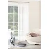 A sheer white curtain hangs in front of a window, with a sofa and decorative vases in the foreground. Produktbild-Vorschau