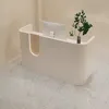 A modern, minimalist reception desk with a computer monitor and a small plant. Produktbild-Vorschau