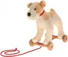 A plush toy dog on wooden wheels with a red pull string against a white background. Anteprima dell’immagine prodotto