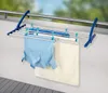 A clothes drying rack attached to a balcony railing, with clothes hanging on it. Produktbild-Vorschau