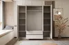 An open wardrobe with shelves and drawers in a room with a window seat and decorative elements. Produktbild-Vorschau
