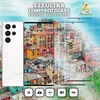 A white Samsung S22 Ultra phone and two clear screen protectors are shown in front of a colorful village scene by the sea. Produktbild-Vorschau