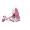 A plush toy rabbit is sitting with its legs extended. Produktbild-Vorschau