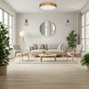 A modern living room with a sofa, chairs, coffee table, and plants. Produktbild-Vorschau