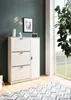 A white shoe cabinet with three drawers and a door stands against a dark green wall, next to a large window with greenery outside. A patterned rug is on the wooden floor in front of the cabinet. Produktbild-Vorschau