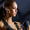 A woman in athletic wear wearing a Bluetooth headset and holding a dumbbell. Produktbild-Vorschau