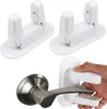 A collage showing two white window/door handle locks and a close-up of one being demonstrated on a silver door handle. Náhled obrázku produktu