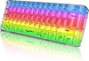 A transparent RGB gaming keyboard with a rainbow color scheme is shown from a slightly elevated front-right angle, with its reflection visible below. Produktbild-Vorschau