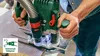 A person is using a Bosch router with a dust collection system attached. Voir les images du produit