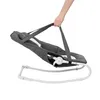 A hand holding a baby bouncer by its straps. Produktbild-Vorschau