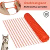 A roll of orange plastic safety netting is shown, with a close-up of hands stretching the material and a husky dog looking up at the camera. Náhled obrázku produktu