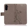 A gray flip phone case with a floral and butterfly embossed design. Produktbild-Vorschau