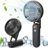 Two black portable fans are shown, one larger and one smaller, surrounded by ice cubes and green leaves, with stylized air currents emanating from the fans. Produktbild-Vorschau