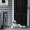 A dog lies on a porch next to a decorative garden sign. Produktbild-Vorschau