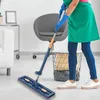 A person is cleaning a floor with a mop in a room with furniture. Náhled obrázku produktu