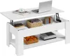 A white lift-top coffee table with storage compartments and shelves, displaying various items like a laptop, books, a basket of fruit, and decorative objects.