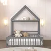 A grey wooden house-shaped bed frame with a mattress and stuffed animals inside, set against a white ribbed wall. Náhľad obrázku produktu