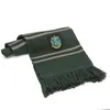 A green and gray striped scarf with a Slytherin crest is folded and lying on a white background. Náhled obrázku produktu