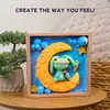 A clay art piece of a bunny on the moon, framed and displayed. Produktbild-Vorschau