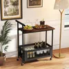 A bar cart with drinks and fruit is placed in a room with a lamp and artwork. Anteprima dell’immagine prodotto