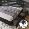 A bed frame with drawers pulled out, showing storage baskets and a wheel detail. Voir les images du produit