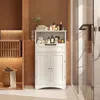 A white bathroom cabinet with shelves and doors, filled with toiletries and towels, placed in a bathroom setting. Náhled obrázku produktu