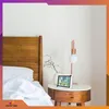 A digital weather station sits on a bedside table next to a bed. Anteprima dell’immagine prodotto
