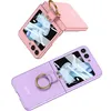 Two flip phone cases with ring holders, one pink and one purple, are displayed against a white background. Produktbild-Vorschau