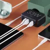 A black 33W USB charging station is plugged into a green power outlet, with multiple white charging cables connected to various devices like smartphones and earbuds. Anteprima dell’immagine prodotto