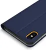 A close-up, angled view of a dark blue flip phone case for an Apple iPhone XR, showing the camera cutout with a yellow accent. Produktbild-Vorschau