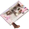A box of chocolates shaped like fashion items, with a separate chocolate shoe in the foreground. Produktbild-Vorschau
