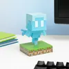 A Minecraft Allay figurine on a grassy block base, placed on a desk next to a stack of books and a keyboard. Anteprima dell’immagine prodotto