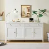 A white sideboard with four doors and two drawers, decorated with a lamp, a painting, a jewelry box, and a plant. Produktbild-Vorschau