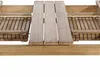 A close-up view of a wooden table with an extension mechanism. Produktbild-Vorschau