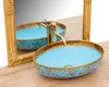 A bathroom sink with a gold faucet and a gold-framed mirror. Náhľad obrázku produktu