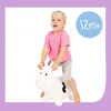 A young child is riding a white inflatable cow toy. Anteprima dell’immagine prodotto