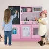 Two children are playing with a pink toy kitchen. Produktbild-Vorschau