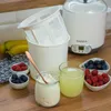 A yogurt maker with accompanying ingredients and finished product. Náhled obrázku produktu
