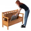 A woman is placing a cushion into a wooden storage bench. Náhled obrázku produktu