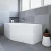 A modern bathroom with a white corner bathtub, grey tiled walls, and a small potted plant. Voir les images du produit
