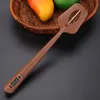 A brown digital food thermometer with a display screen is placed on a dark surface next to a basket of fruit. Podgląd zdjęcia produktu