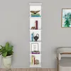 A white wall-mounted shelf unit with various decorative items and books. Náhľad obrázku produktu