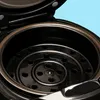 Close-up view inside a black multi-cooker pot, showing the steaming rack. Anteprima dell’immagine prodotto